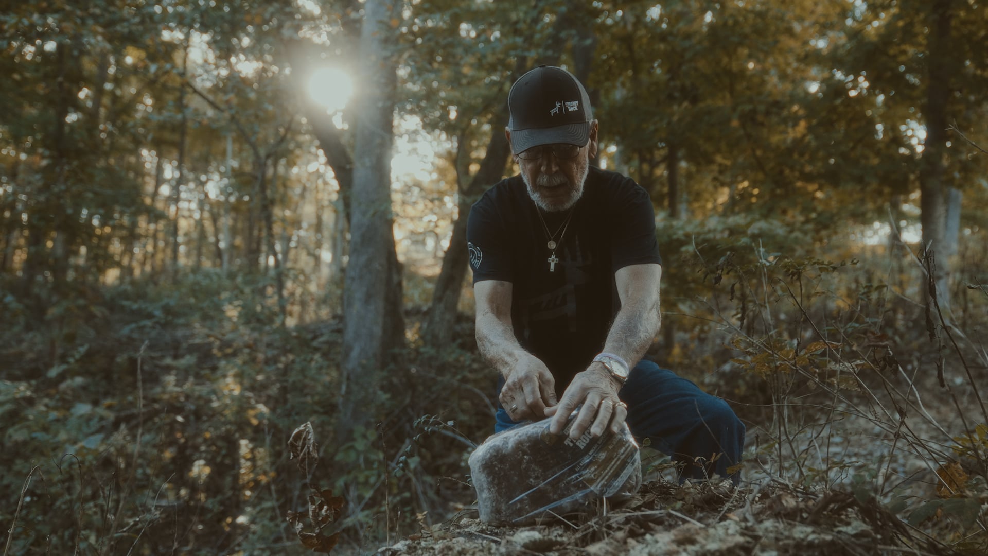 Joe Anderson, the grandfather of Trophy Rock, sets out a rock at one of his deer mineral sites.